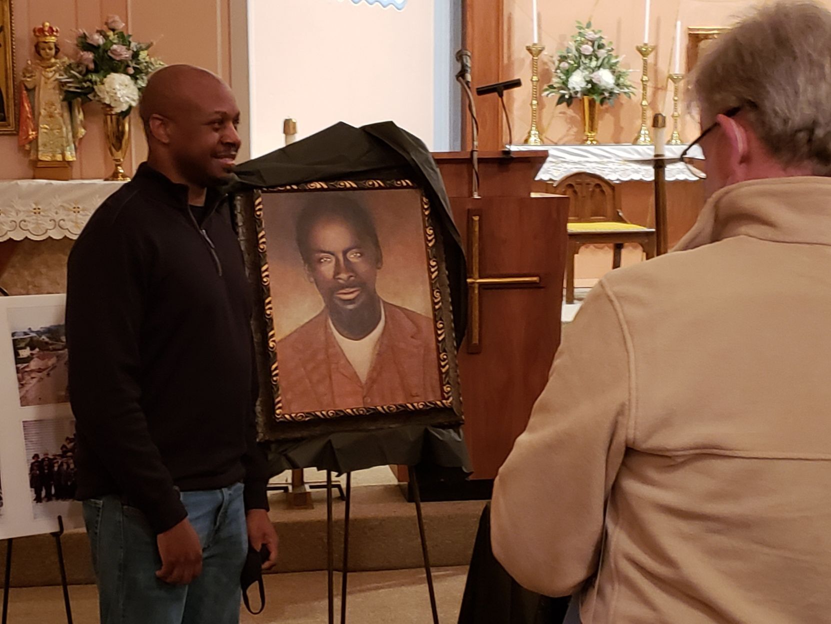 Brant Riney of Florissant stands before a modern portrait of Moses Riney